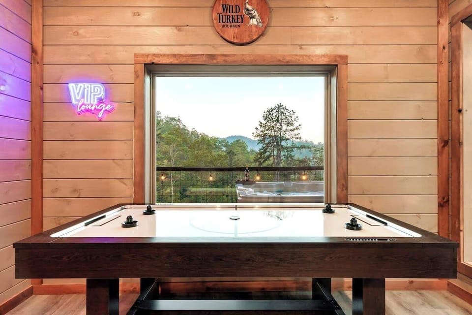 Game room in basement with Pool table, Shuffle board, Air hockey table, dart game, 23000 + Arcade game, poker table for 8, Queen Murphy Bed for extra guests, Media room with 75" smart TV, electric fireplace. 