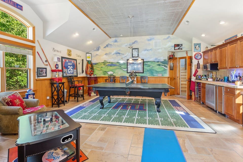 Engage in some friendly competition in the Game Room with a Ping Pong Table, Pool Table, Foosball Table, Wet Bar, and Flat Screen TV!