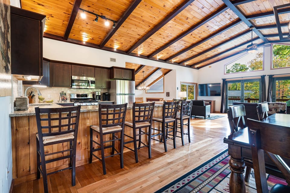 The great room. This room is located on the second floor. There's a fireplace, 65" TV, huge kitchen peninsula, and more! The kitchen is fully equipped