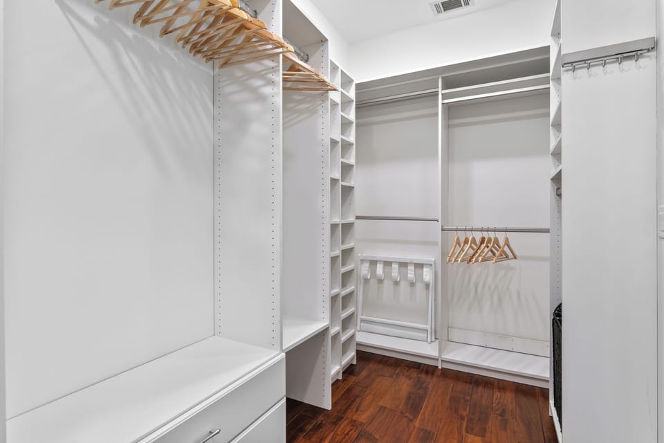 Primary bathroom with glass shower, soaking tub and walk in closet