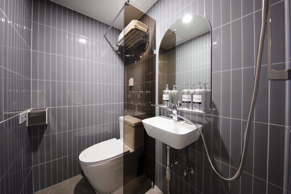 Quadruple Room | Bathroom | Shower, hair dryer, slippers, towels