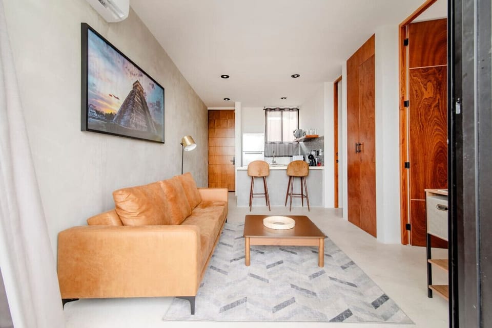 Living Room Oasis: Chic leather sofa, vibrant art, and a perfect spot for sunset sipping!