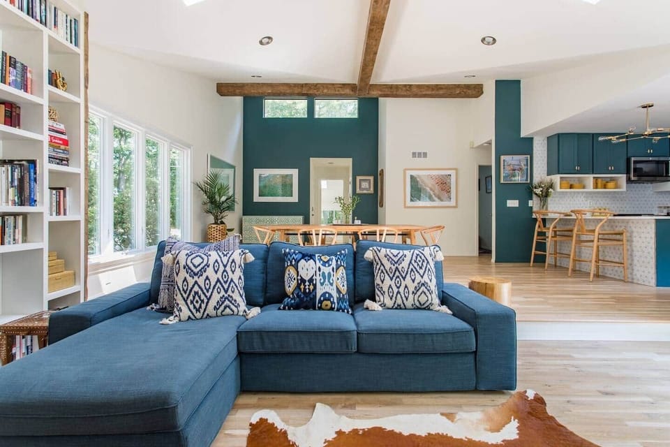 Living room with vaulted ceiling and exposed beams. 