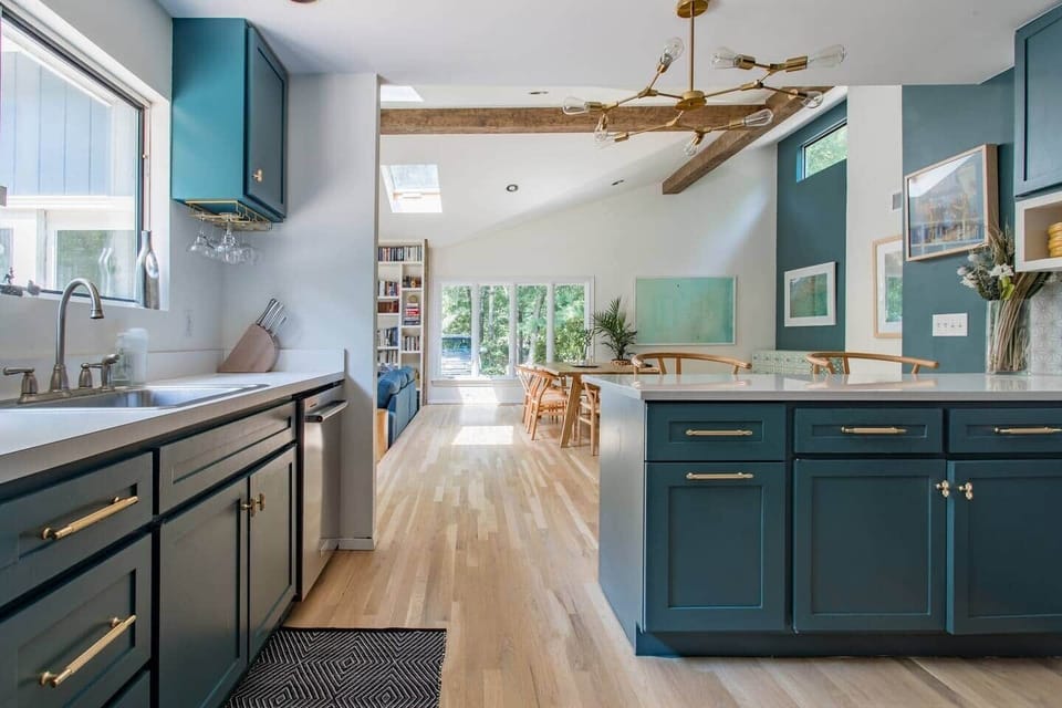 The kitchen is fully stocked with clean and contemporary implements. View is open to dinning room and out to the pool deck. 