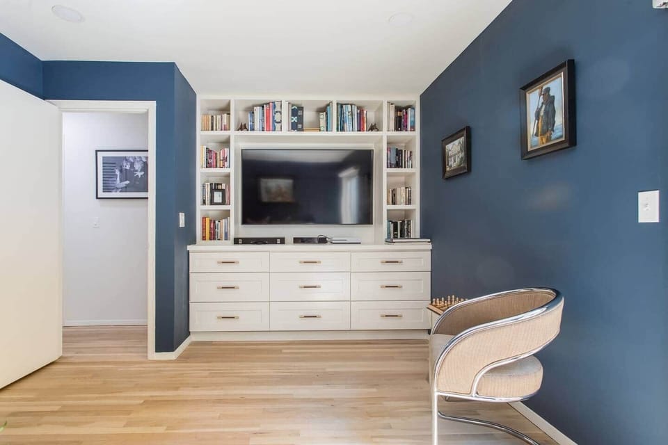 TV room.  Flat screen smart TV. Film library. Drawers of board games and toys. 