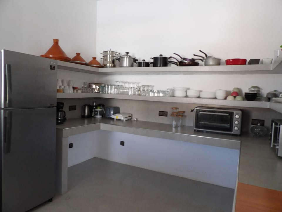 Fully equipped open kitchen, hob, fridge, freezer, dishwasher, electric oven, microwave, small appliances, dishes