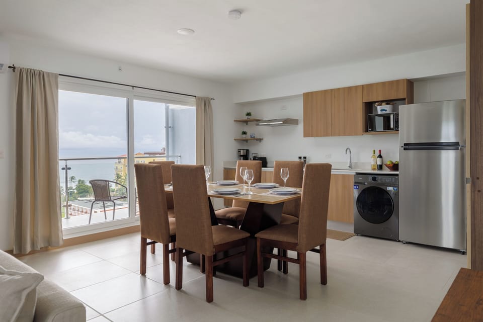 Fully-furnished kitchen and dining area with ocean views