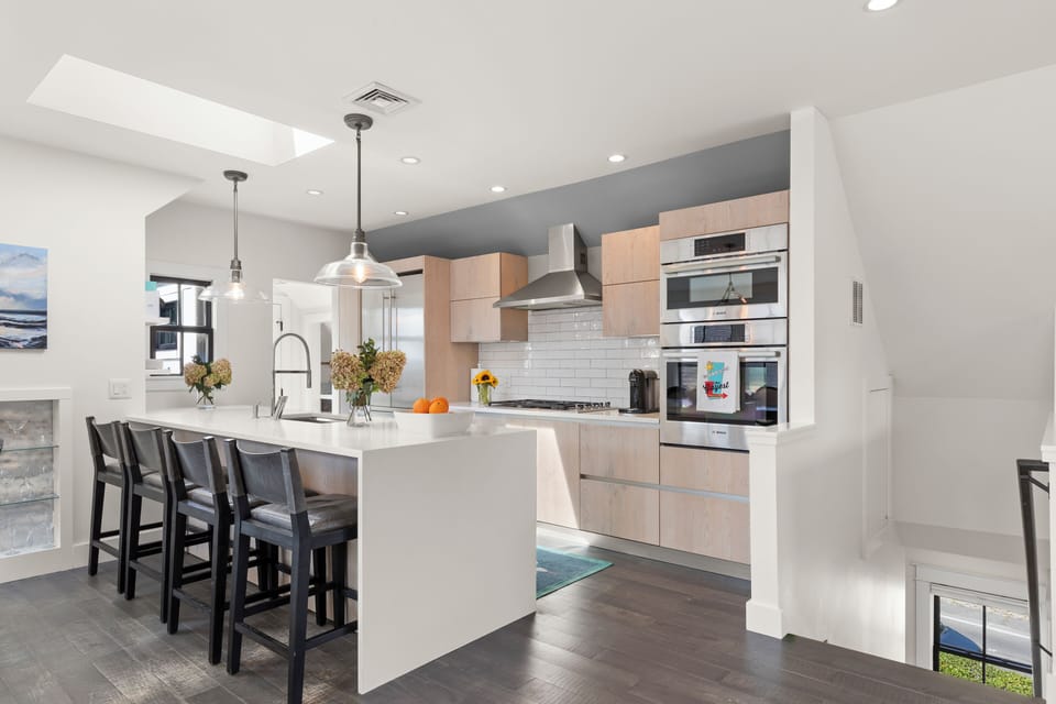 The large island for four invites casual dining under elegant pendant lights.