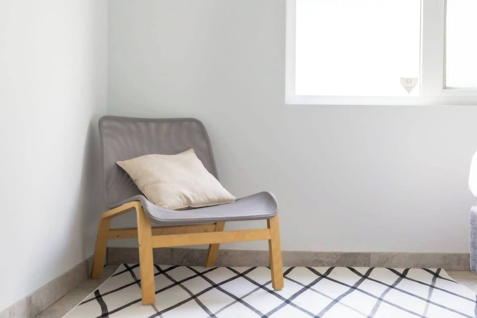 Enjoy quiet moments or dive into a good book on the comfortable lounge chair in the first bedroom