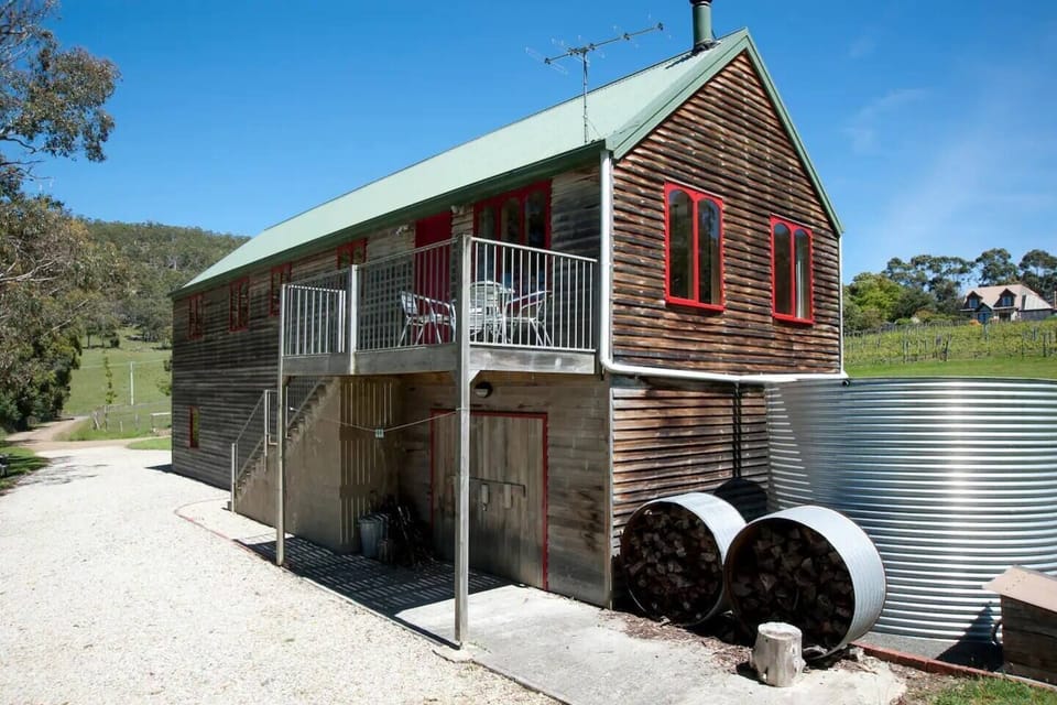 Nestled amid 12 acres of dreamy rural gardens with distant ocean views, the ‘Wine Loft’ has been converted into a bright and sunny sanctuary with a cosy, country-style charm. 