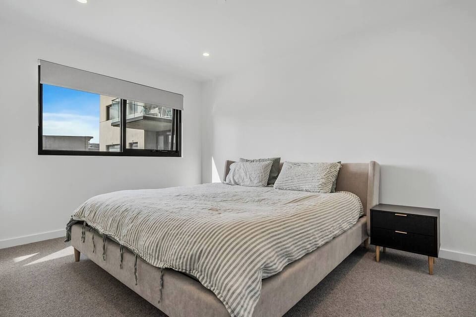 The bedroom offers a plush king bed, providing a serene retreat after a day of exploring the city. 