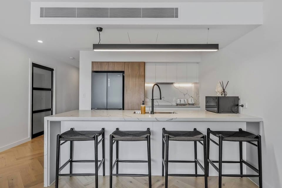 Gather around the dining area set for four, conveniently located in the kitchen space, perfect for enjoying home-cooked meals or morning coffee together.