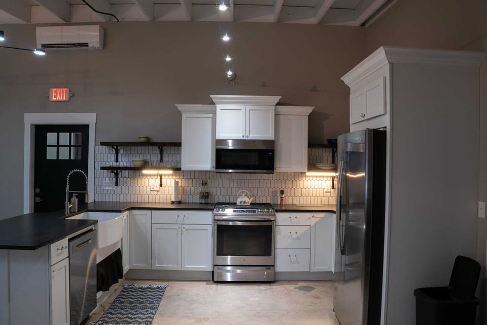 Full kitchen fully furnished with pots/pans cooking utensils