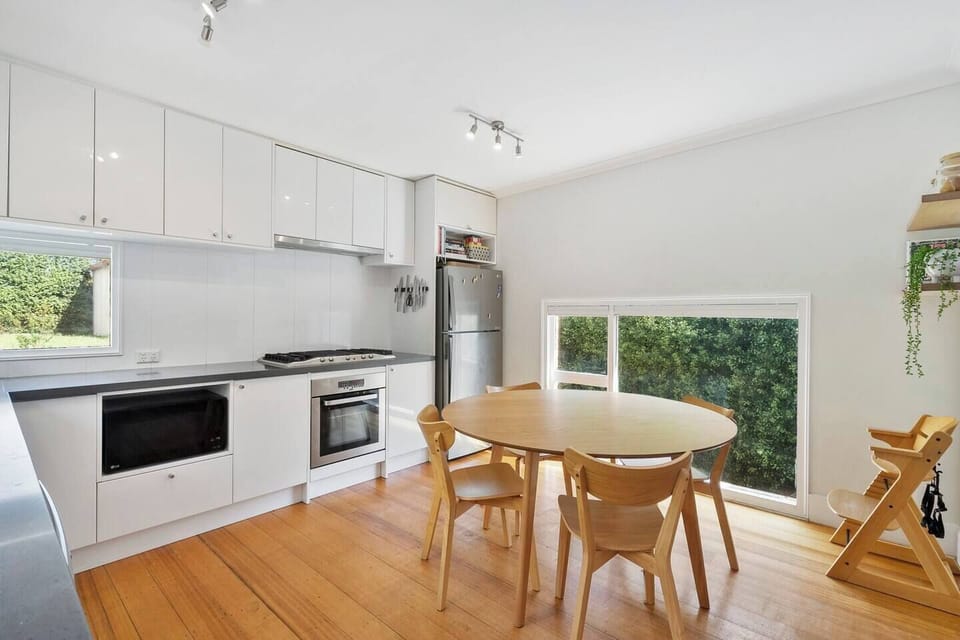 Come together for a shared meal around the dining table by the kitchen, with a high chair for the little one.