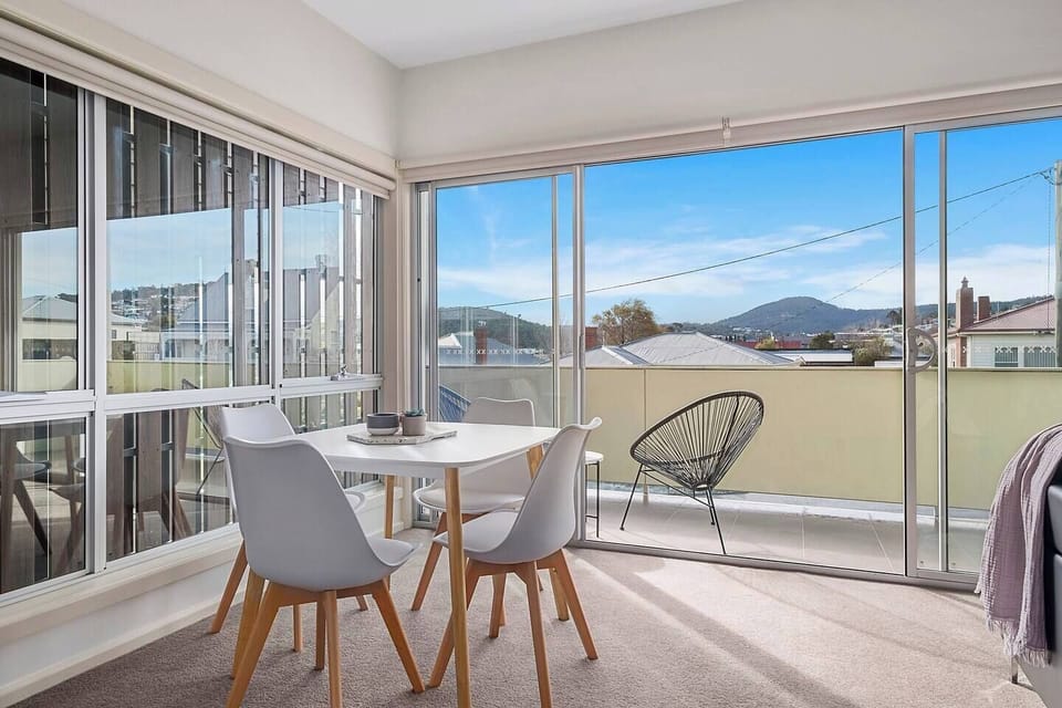A four-seater dining area accommodates all guests for meals at home with views of Mount Wellington.