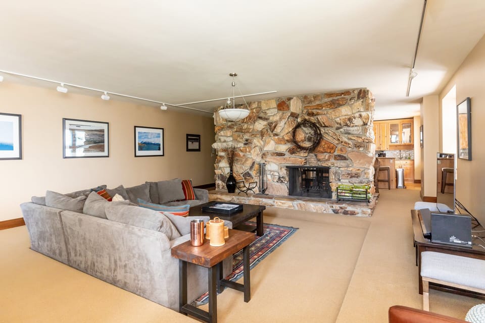 See through fireplace to dining area and kitchen