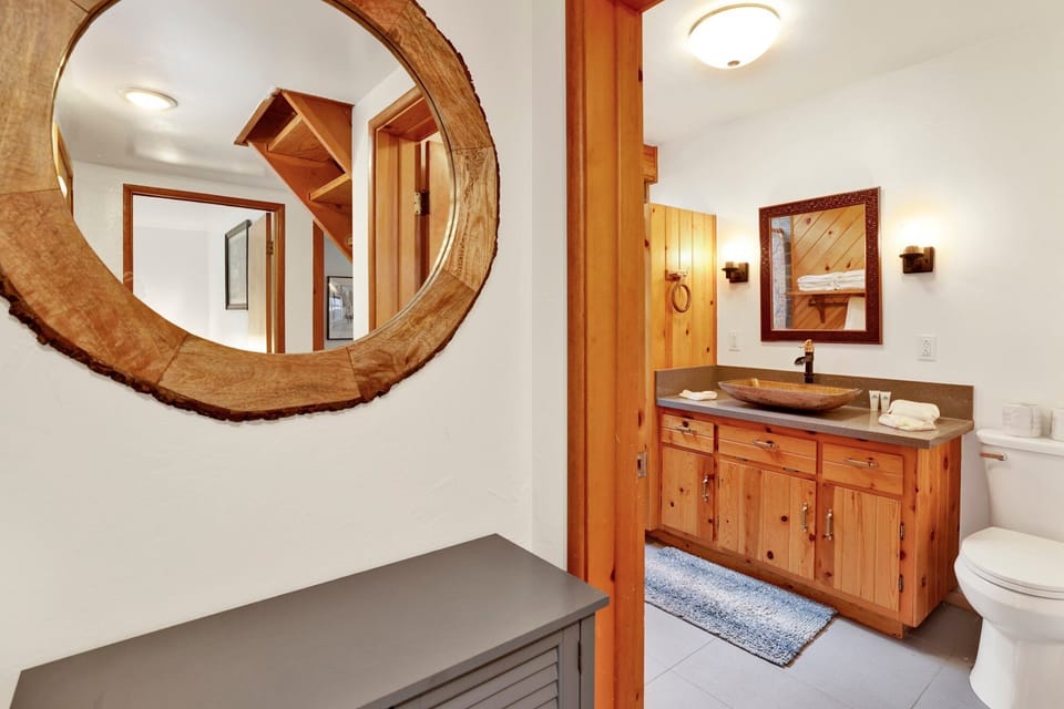 Clean and cozy cabin bathroom with a shower, sink, and toilet—simple, fresh, and comfortable for your everyday needs during a relaxing mountain stay.
