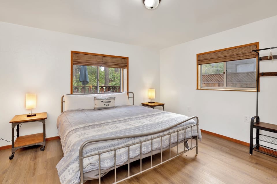 Peaceful cabin bedroom with plush bedding, and beautiful views—ideal for restful nights, cozy mornings, and a relaxing mountain escape.
