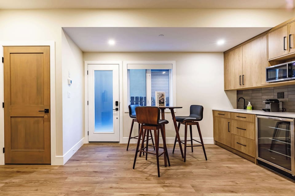 The private downstairs suite boasts a lovely dining area with 4 chairs, kitchenette, and an in-suite laundry (the door to the left). There is a private entrance allowing you to come and go separately from the main entrance.