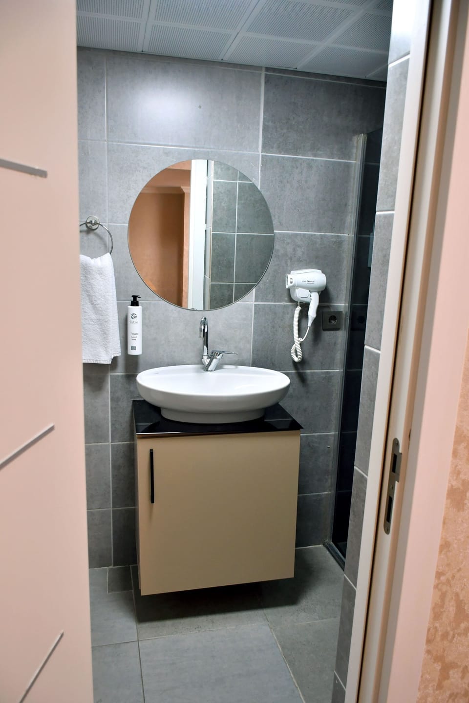 Shower, hair dryer, slippers, towels