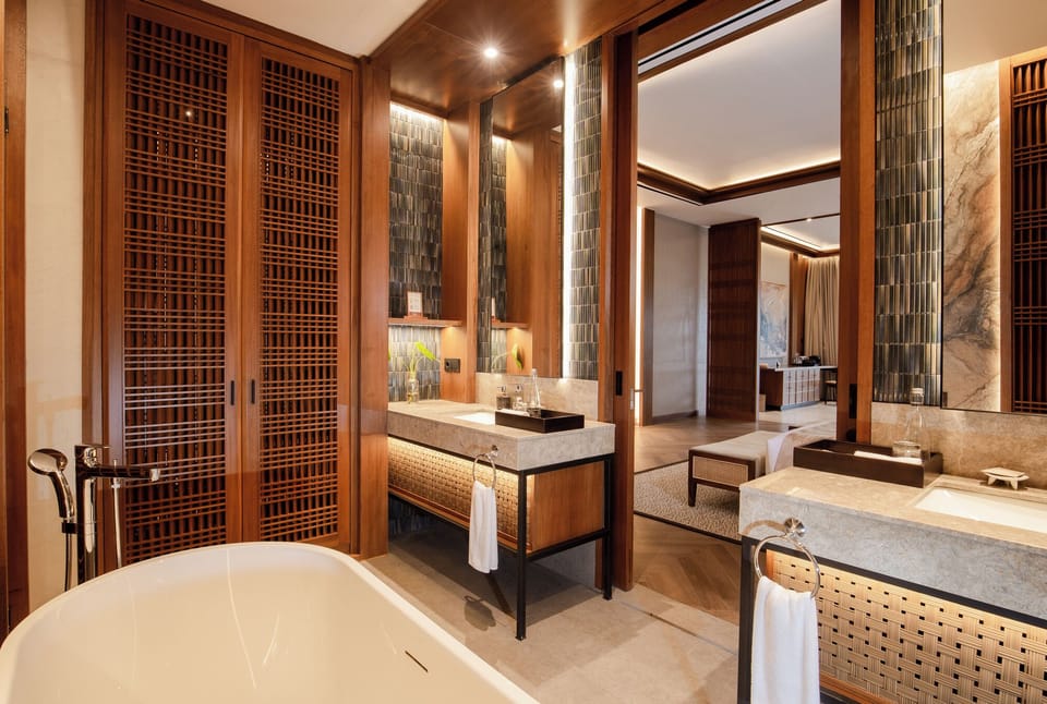 Bathtub, hair dryer, slippers, towels