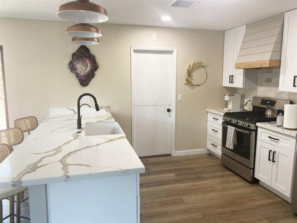 Modern kitchen with marble counters and chic décor, perfect for culinary creations!