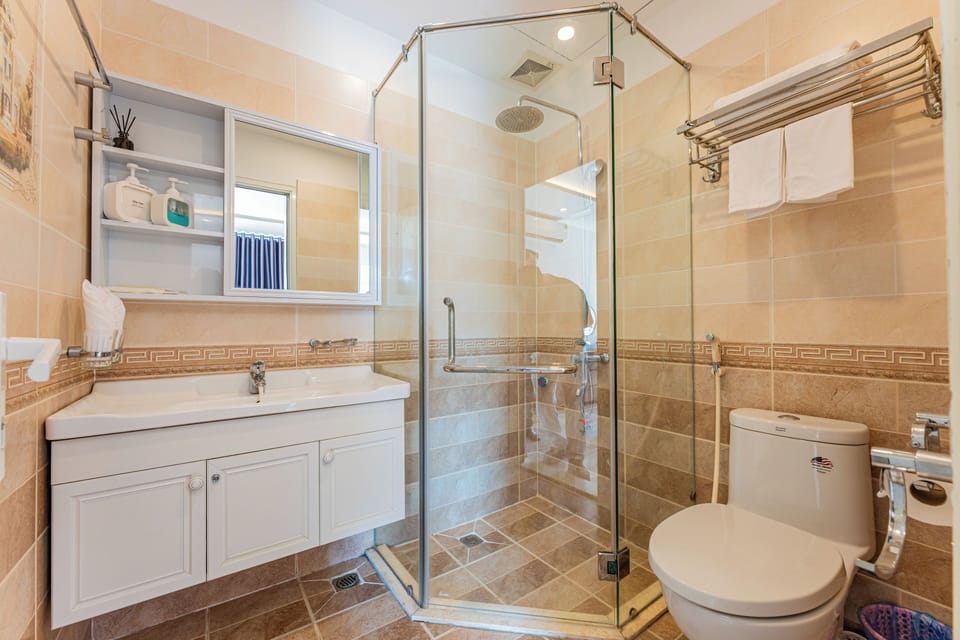 Shower, designer toiletries, hair dryer, bathrobes