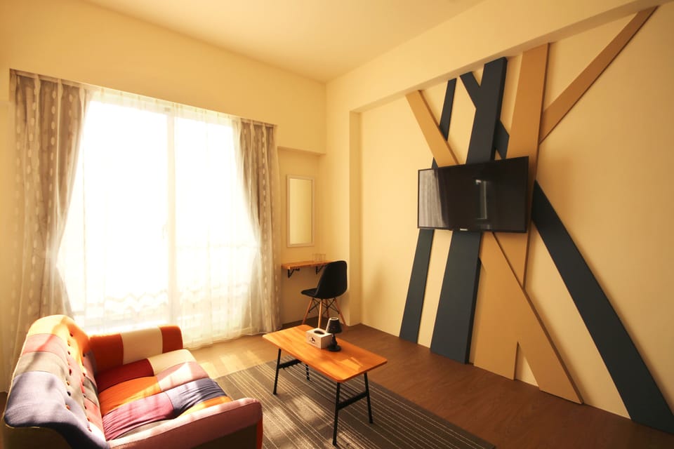 Standard Quadruple Room | Living area | 42-inch flat-screen TV with cable channels, TV