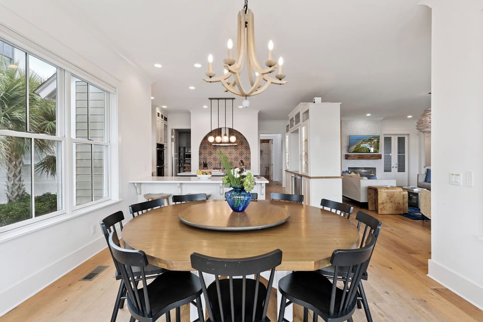 Gather around this stunning dining space where your family meals become memorable moments under elegant lighting.