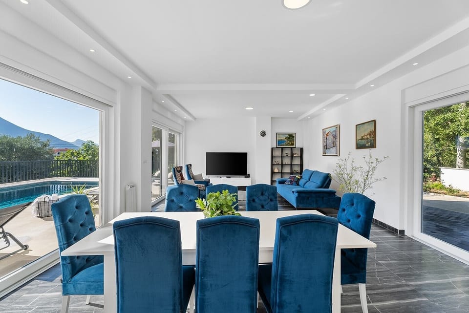 Elegant living room with air conditioning, couches, flat-screen TV