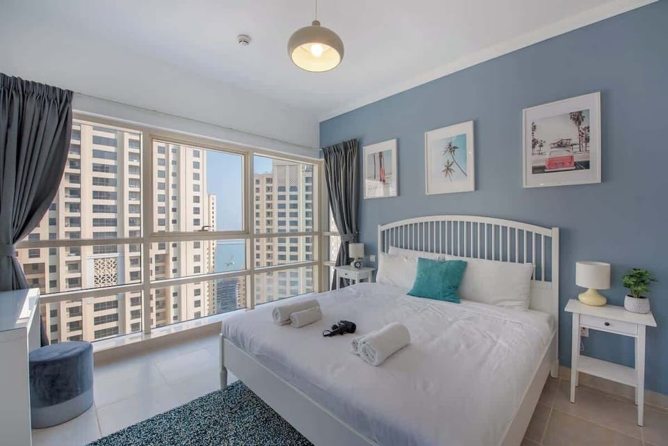 Bedroom with floor to ceiling windows 