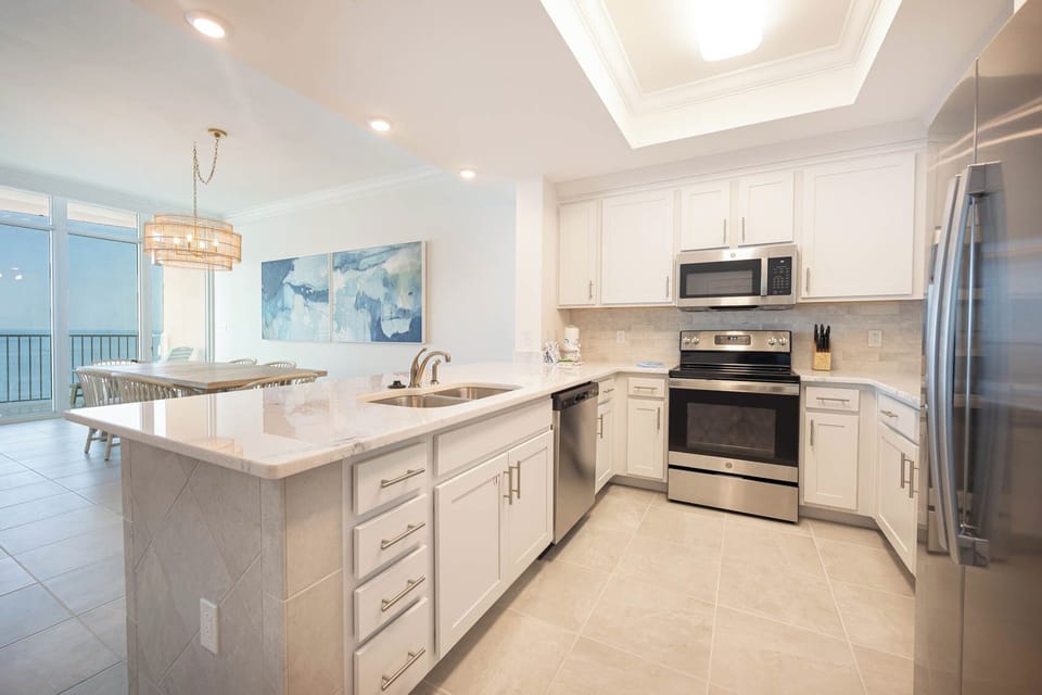 Prepare meals in this kitchen with elegant cabinetry, stainless appliances, and spacious countertops
