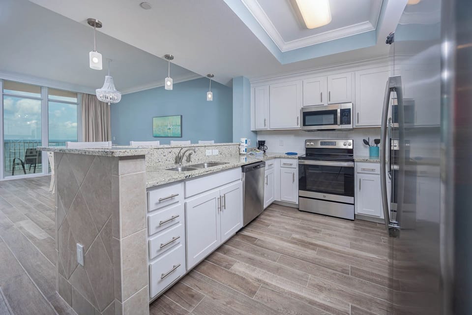 Prepare meals in this kitchen with elegant cabinetry, stainless appliances, and spacious countertops