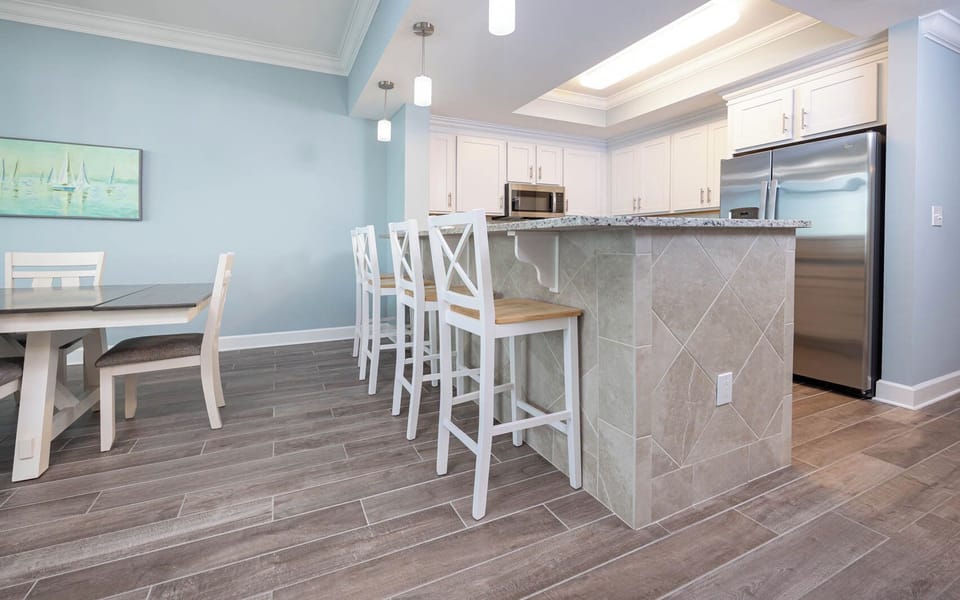 Sip your morning coffee at the breakfast bar and get ready for a beach day in this stylish space