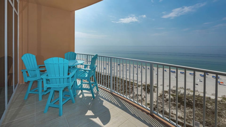 Lounge on the turquoise chairs, feel the gulf breeze, and watch the beach from the balcony