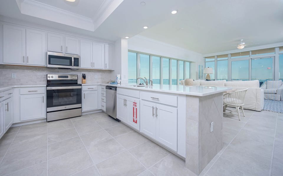 Prepare meals in this kitchen with elegant cabinetry, stainless appliances, and spacious countertops
