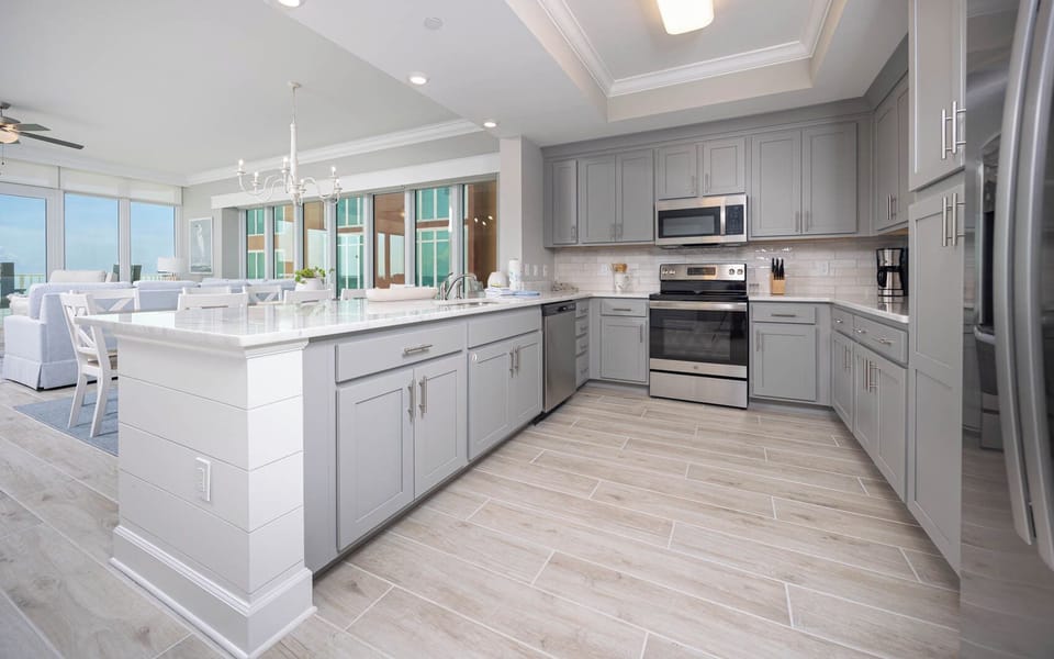 Prepare meals in this kitchen with elegant cabinetry, stainless appliances, and spacious countertops