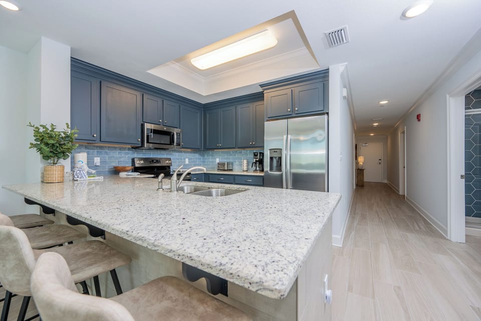 Sip your morning coffee at the breakfast bar and get ready for a beach day in this stylish space