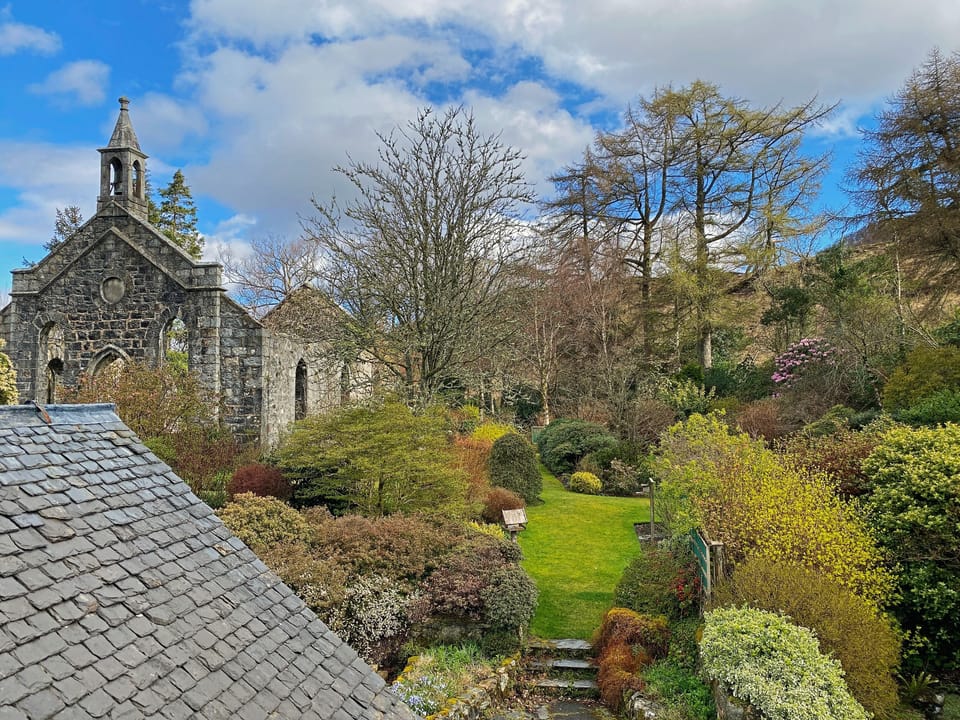 View from bedroom 1: Back garden with church ruins.