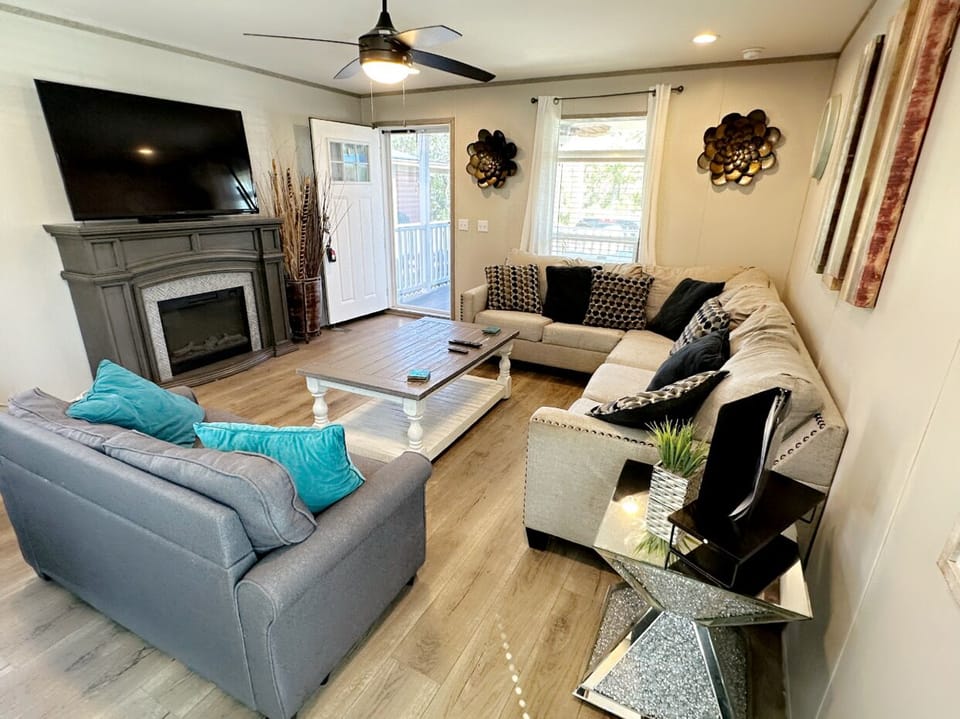 L shape living room plus sofa bed, Smart TV with fire stick and fireplace.
