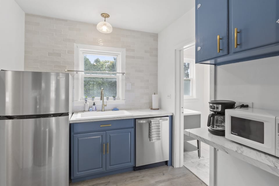 Bright, updated kitchen with stainless appliances, ample counter space, and a deep farmhouse sink—fully equipped for cooking before heading out to explore Watkins Glen, Seneca Lake wineries, and local trails.