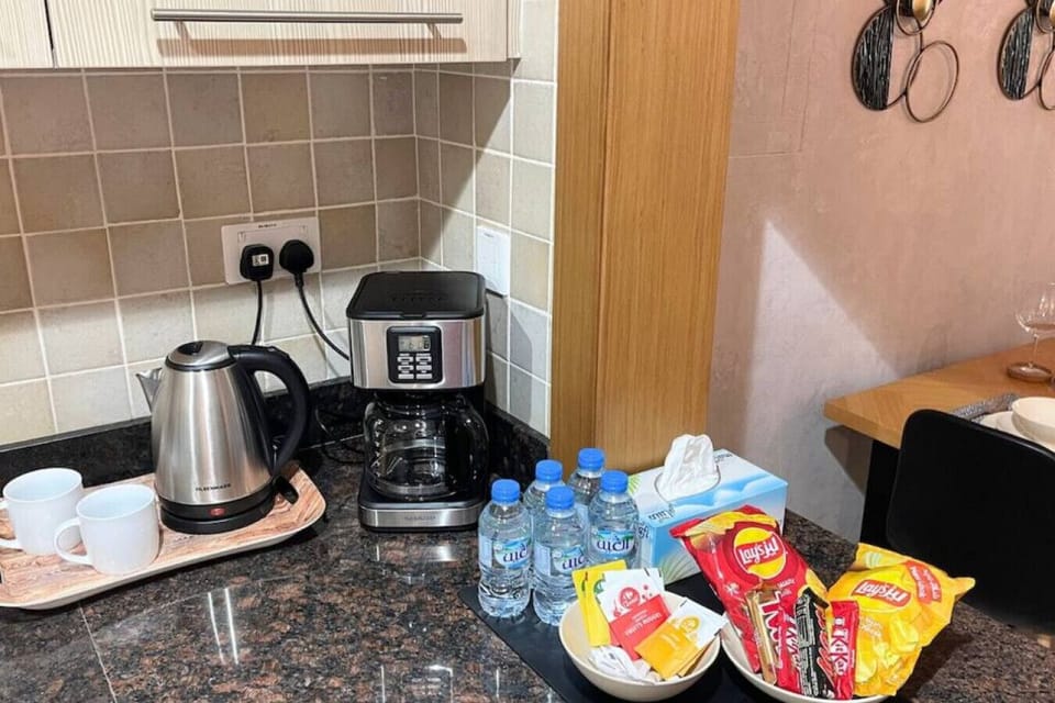 Satisfy cravings with ease – electric kettle, refreshing water, and tempting snacks at your fingertips.