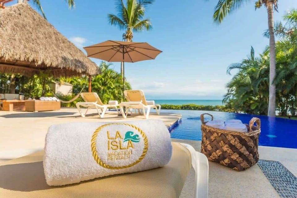 Poolside comfort with ocean views, fresh towels, and a tropical setting made for relaxing.