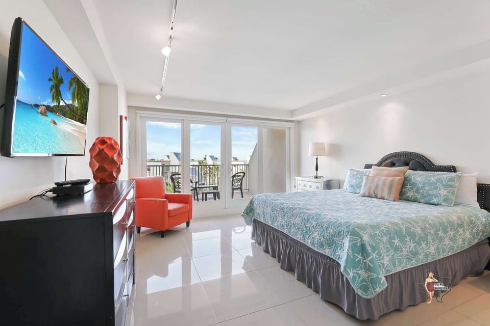 Bedroom 1 has a king-size bed and direct access to the balcony.