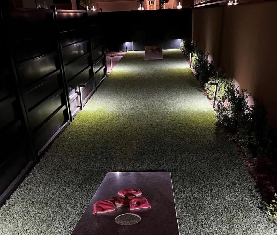 30 - Custom cornhole court nestled on the side of the home