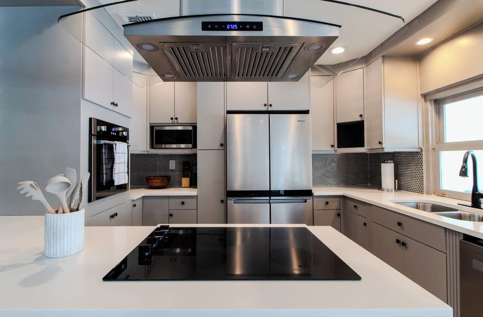 Kitchen with stove with range hood