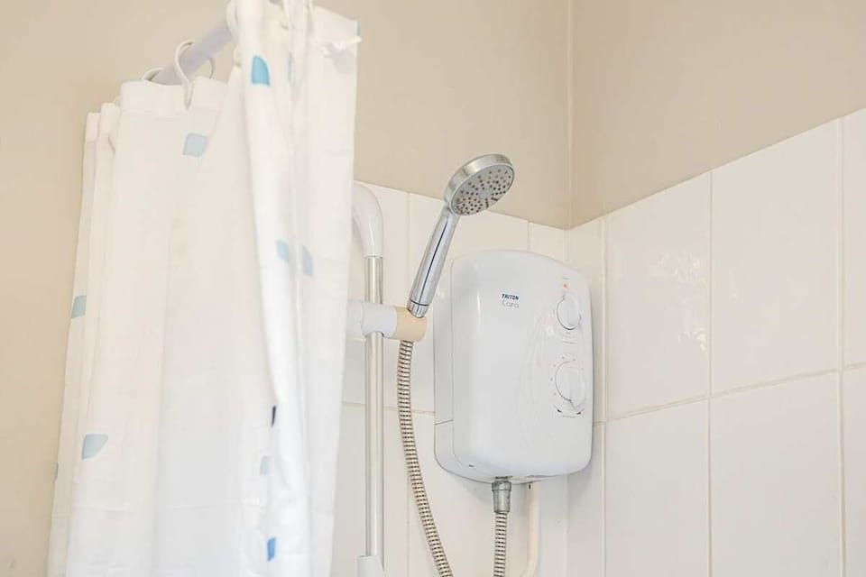 Offering both a luxurious bath and an overhead shower, this bathroom ensures a comfortable and versatile experience
