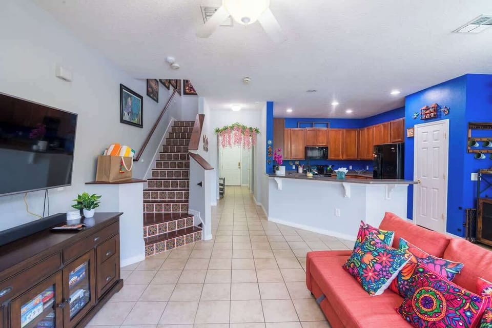 A bright and spacious open-concept area connecting the kitchen, living room, and dining space.