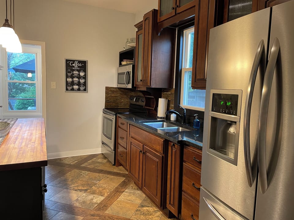 Full Kitchen with Oven, Stone, Fridge, Dishwasher, Sink, Microwave, and Coffee.