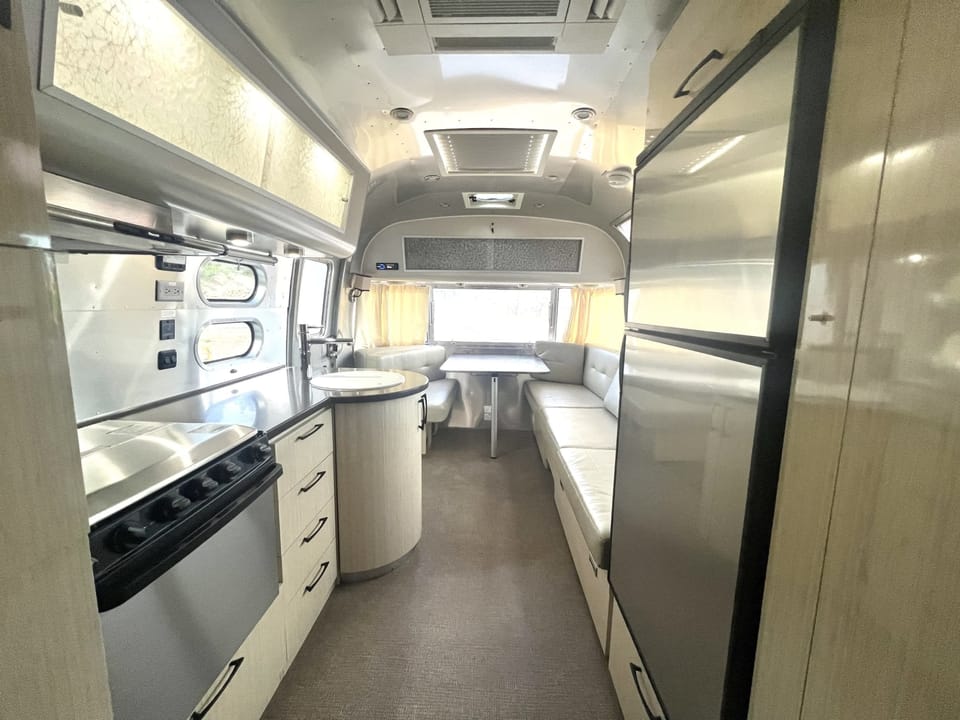 Bright Airstream interior with a cozy camper layout and modern glamping comforts near Zion National Park and Bryce Canyon.